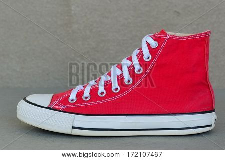 close up vintage style of sport red sneaker shoe on gray background