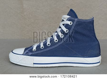 close up vintage style of sport blue sneaker shoe on gray background