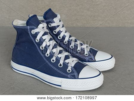 close up vintage style of sport blue sneaker shoe on gray background