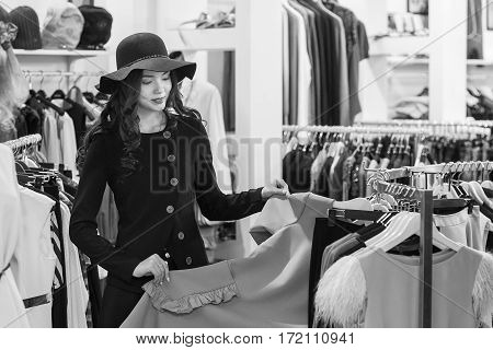 Young woman is shopping in clothing store