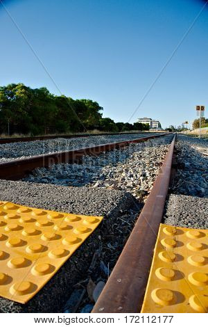 Low angle shot of a train track with tactile paving