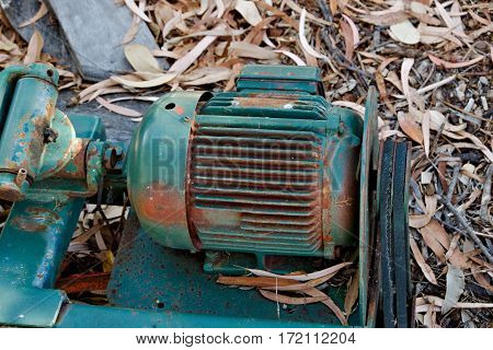 Part of a rusty green agriculture machine