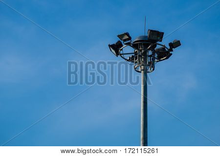 A part of top multi street light pole with blue sky background.