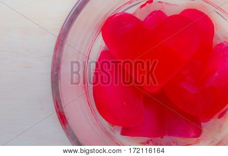 Ice heart-shaped in a glass on day of love.
