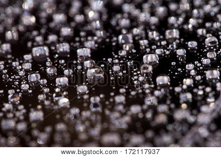 Abstract black-white background with gradient color water drops on glass with reflection, bockeh, macro