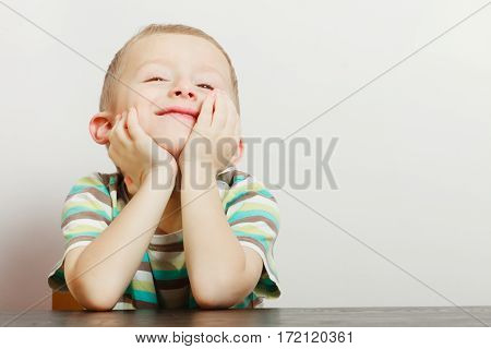 Boredom face expression concept. Little boy making funny faces being bored he wants to play with somebody