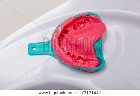 Silicone dental imprint washed and placed on the white sink