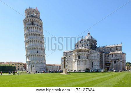 Pisa Italy - September 26 2016:  Tourist in the Piazza dei Miracoli in pisa with the Pisa tower and the church