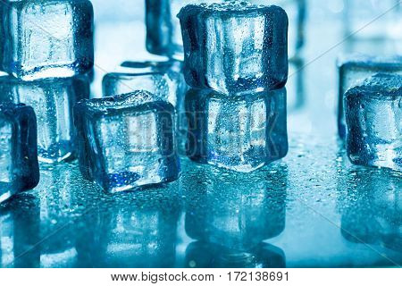 Group of melting ice cubes on glass table