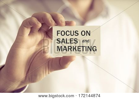 Businessman Holding Focus On Sales And Marketing Message Card
