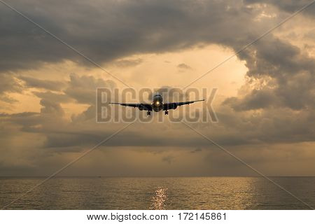 Landscape of sunset with Plane from Phuket at Nai Yang Beach Phuket Province Thailand.