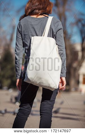 Girl with ecobag over his shoulder outdoors
