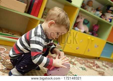 Сhild playing with a toy in kindergarten