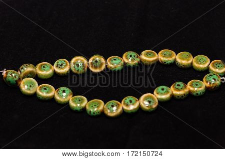 a string of green, yellow and brown beads