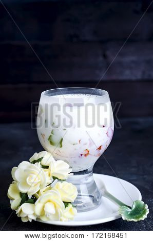 Dessert in a glass with hearts on a dark concrete background