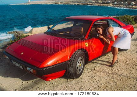Young Girl Do Makeup In The Rear View Mirror Of Ferrari