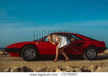 Young Girl Do Makeup In The Rear View Mirror Of Ferrari