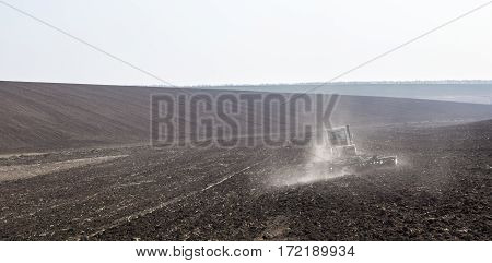 Harrowing the soil with disc harrows in spring in Ukraine.
