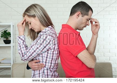 Man and woman standing back to back after quarrel isolated