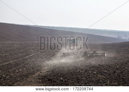 Harrowing the soil with disc harrows in spring in Ukraine.
