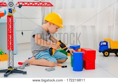 A boy plays in the builder in the room