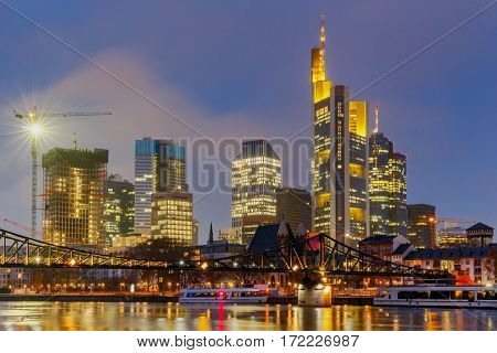 Picturesque views of the city's waterfront and skyscrapers at night in Frankfurt. Germany.