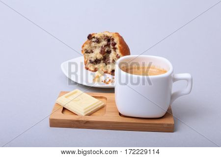 Classic espresso in white cup with cake and chocolate on white background