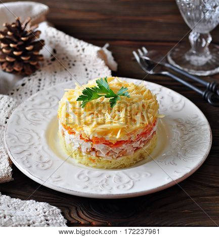 Salad of boiled potatoes, carrots, eggs, hard cheese, smoked chicken breast and white onion with mayonnaise. Russian traditional festive salad.