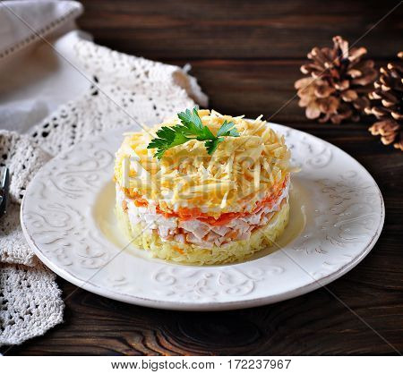 Salad of boiled potatoes, carrots, eggs, hard cheese, smoked chicken breast and white onion with mayonnaise. Russian traditional festive salad.