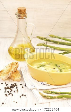 Asparagus soup with a toast bread and olive oil