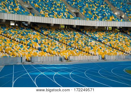 Empty colorful stadium seats and running tracks
