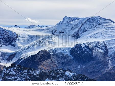 View from Mt. Titlis in Switzerland on an overcast day in winter. The Titlis a mountain, located on the border between Swiss cantons of Obwalden and Bern.
