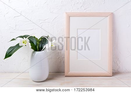 Wooden frame mockup with tender white lily in vase. Empty frame mock up for presentation design.