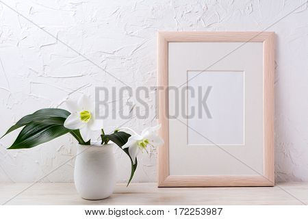 Wooden frame mockup with white lily in flower pot. Empty frame mock up for presentation design.