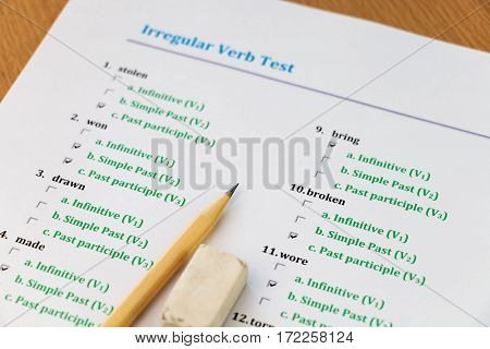 multiple choice english exam on table with pencil