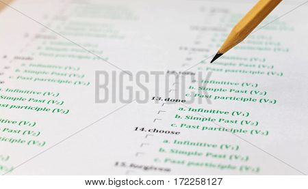 multiple choice english exam on table with pencil