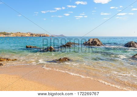 Playa el Chileno Beach, Cabo San Lucas, Mexico. Different stages of the fantastic ocean waves. Rocky and sandy beach.