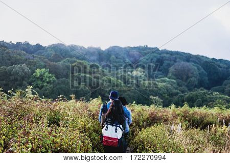 Group of people walking on mountain in morning, trekking on the Kew Mae Parn, National Park mountain