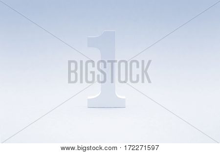 Number one on blue background. Top concept. Wooden number1 as symbol of success