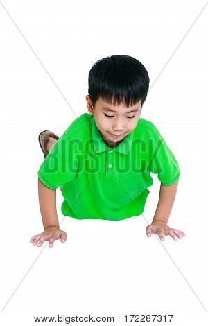 Push-ups or press-ups exercise. Young asian child warming up and doing push-ups. Muscular and strong guy exercising. Isolated on a white background. Sports and active lifestyle. Studio shot.