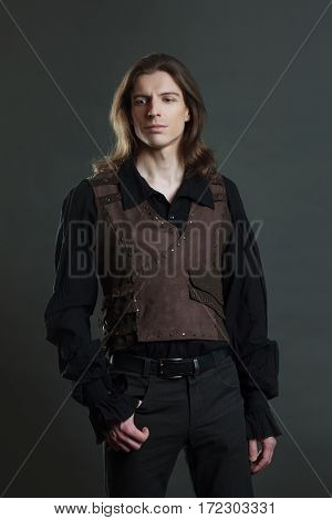 Handsome male Steam punk. Retro man portrait over grunge background.