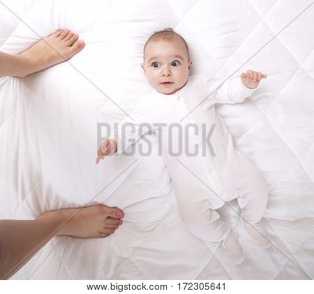 Happy Addorable Baby Boy And The Legs Of His Mother.