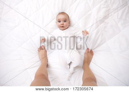 Happy Addorable Baby Boy And The Legs Of His Mother.
