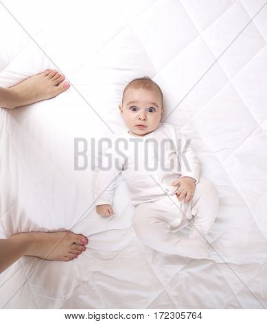 Happy Addorable Baby Boy And The Legs Of His Mother.