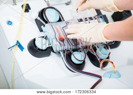 Doctor using Medical device for checking blood during blood donations in hospital