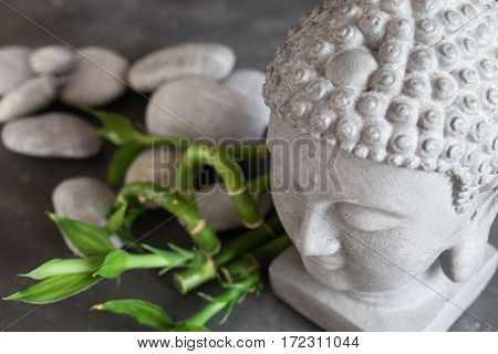 buddha head with stones , bamboo and tabular