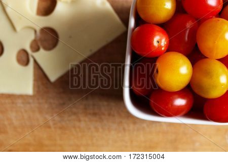 Cherry tomatoes with cheese on a plate