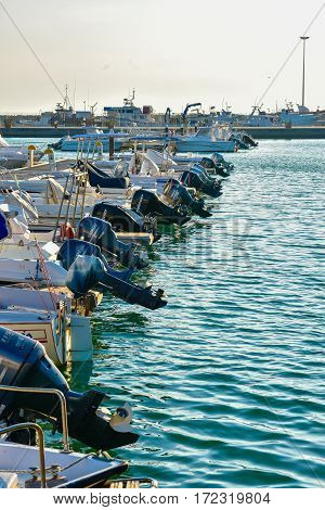ROCCELLA IONICA, ITALY - September 30, 2016: Port of Roccella Ionica in the evening with fishing boats and luxury yachts. Port of Ionian Sea, Calabria, south Italy.