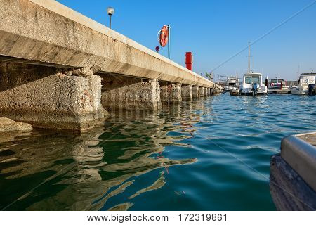 ROCCELLA IONICA, ITALY - September 30, 2016: Port of Roccella Ionica in the evening with fishing boats and luxury yachts. Port of Ionian Sea, Calabria, south Italy.