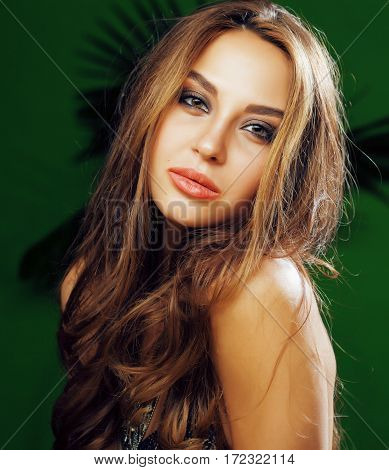 young cute blonde woman on green palm background smiling happy, lifestyle peole concept close up